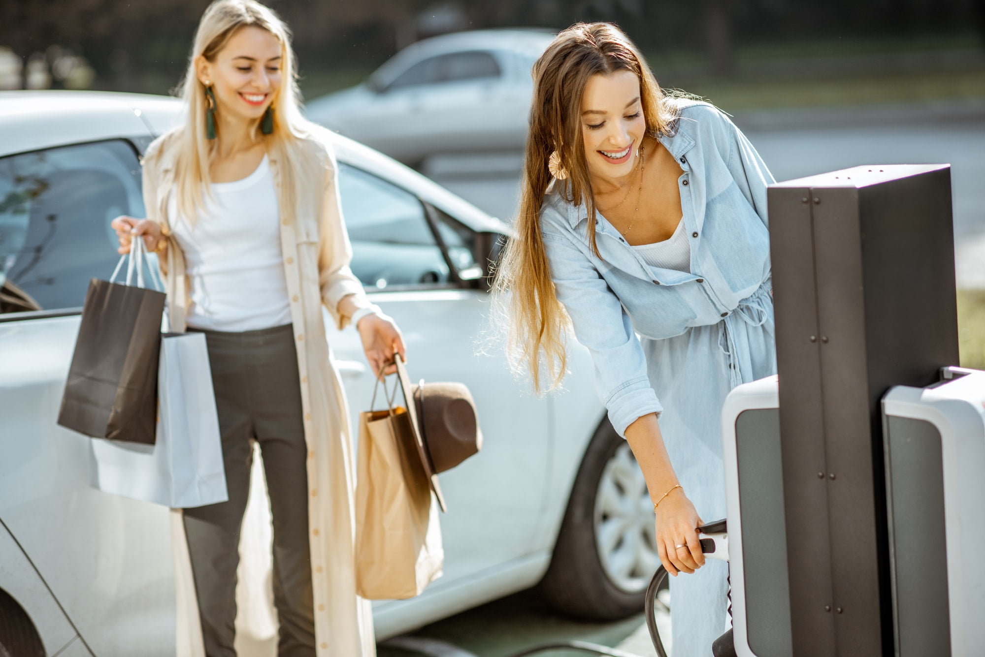 Woman charging electric car