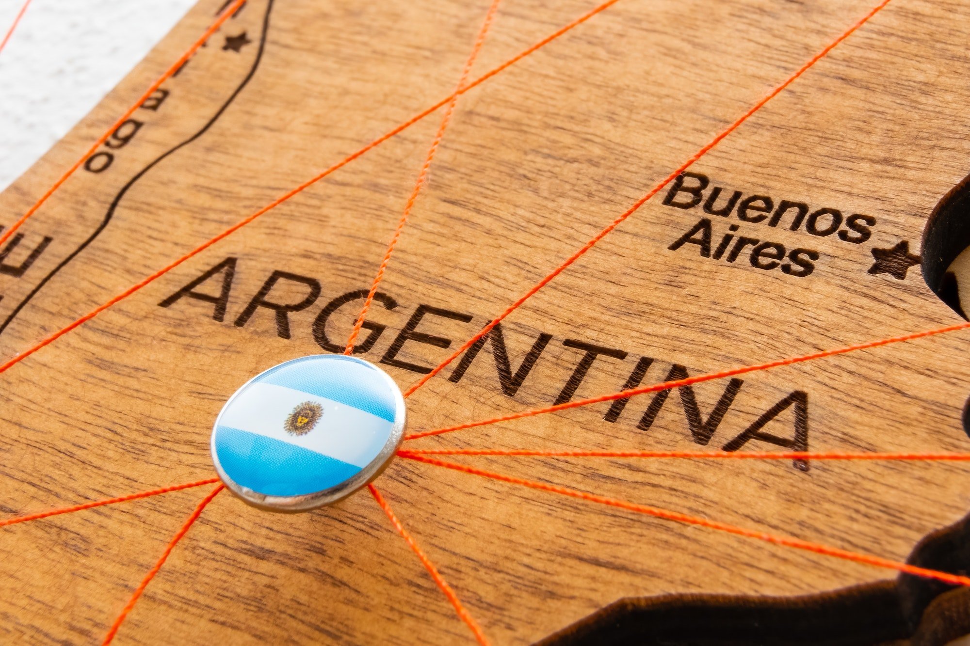 Argentina flag pins and red thread for traveling and planning trip.